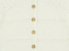 Close-up of the back buttoning, boxwood buttons and alternating jersey and double moss stitch of the ecru Zouzou preemie cardigan