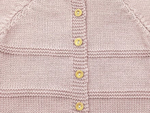 Gros plan sur le boutonnage dos, les boutons en buis et l'alternance de maille jersey et point mousse de la brassière prématuré Zazou rose