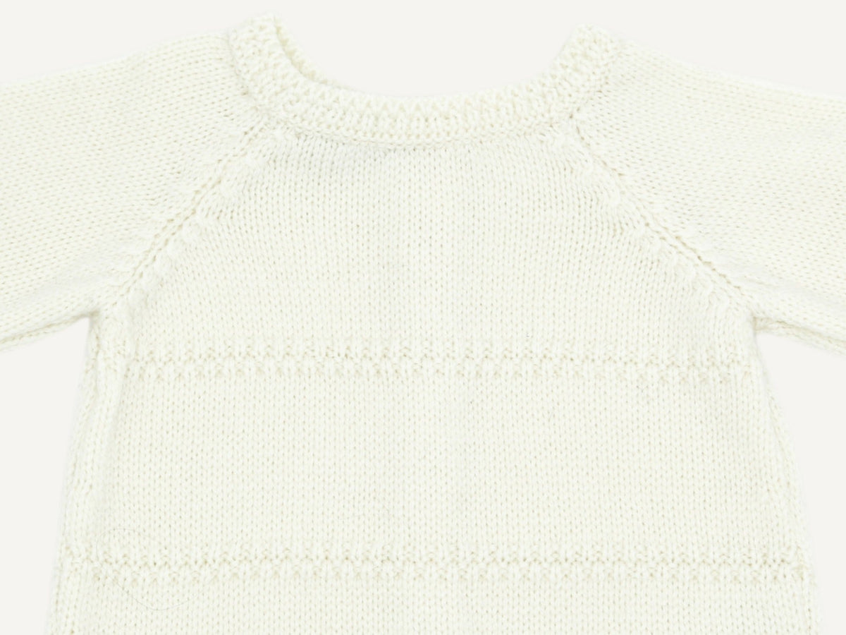 Close-up of the double moss stitch neckline and raglan sleeves of the ecru preemie cardigan