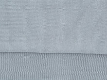 Close-up of the jersey knit and garter stitch border of the blue-grey Tatou baby blanket